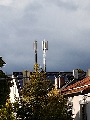 Mobilfunkmast über einem Wohnhaus